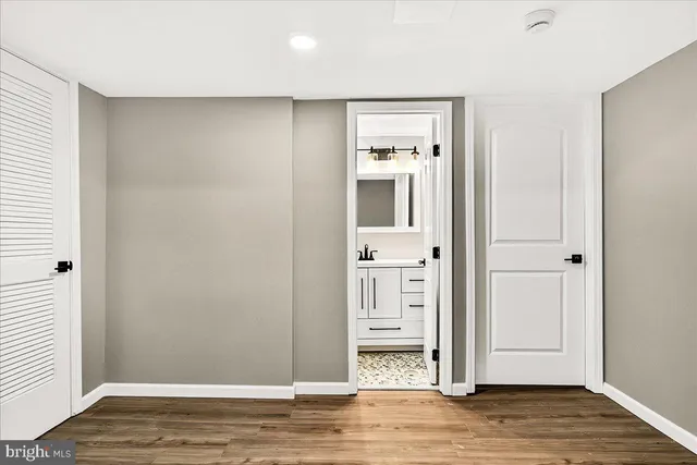 a view of a room with wooden floor
