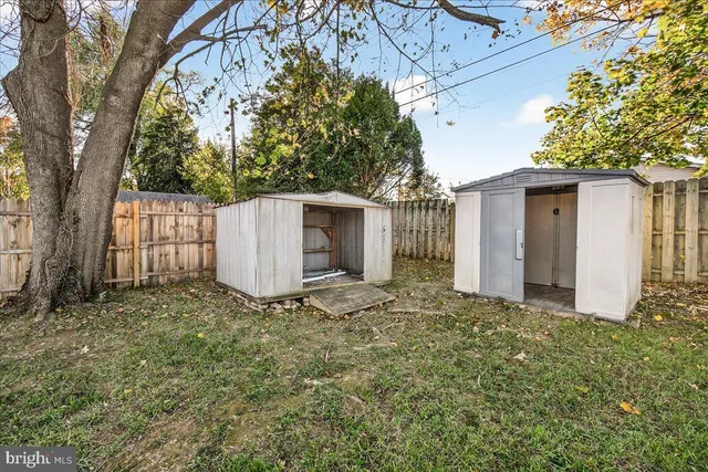 a view of a house with a yard and tree