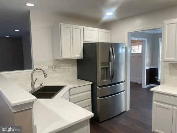 a kitchen with stainless steel appliances a refrigerator sink and microwave