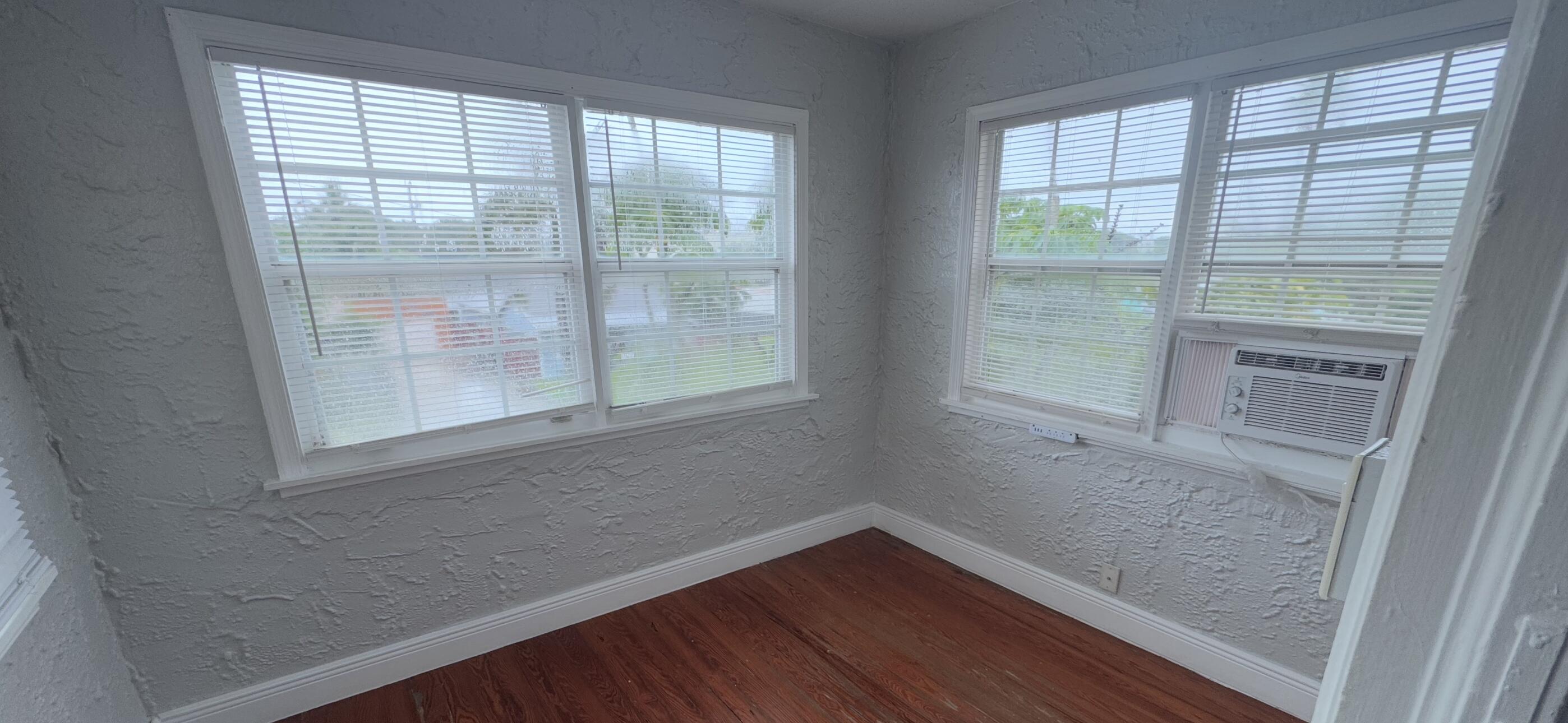 736 Omar Road, Unit 4 West Palm Beach, FL 33405 - Photo 11 of 17 a view of empty room with wooden floor and fan