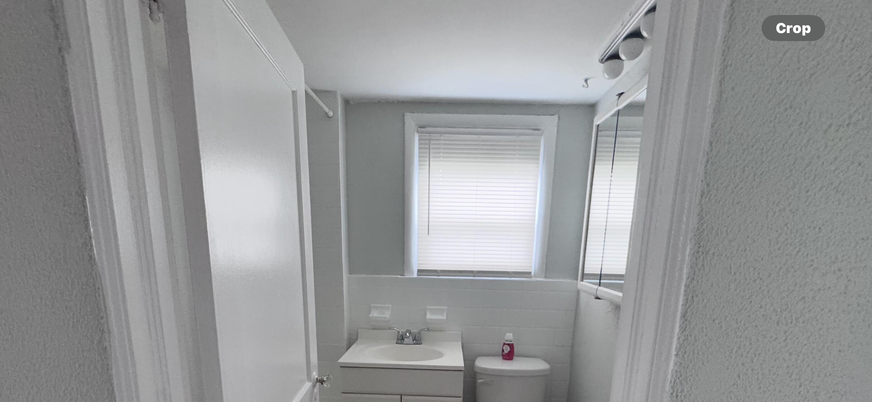 736 Omar Road, Unit 4 West Palm Beach, FL 33405 - Photo 15 of 17 a bathroom with a sink and a window