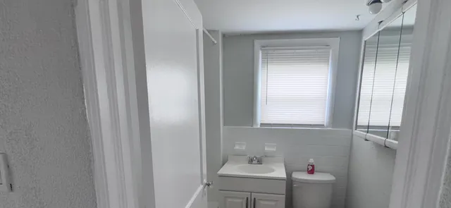 a bathroom with a sink and a window