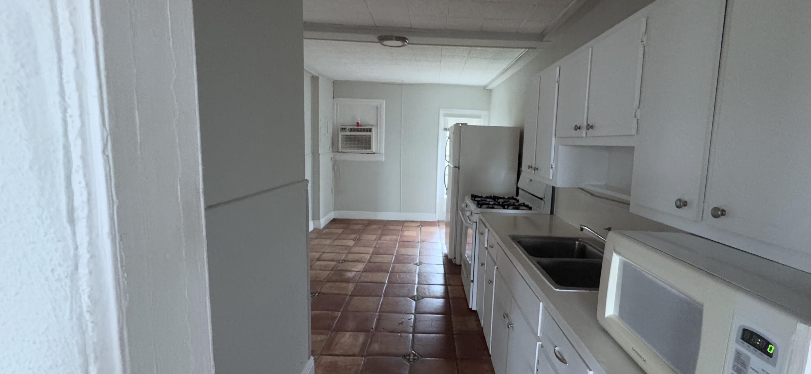 736 Omar Road, Unit 4 West Palm Beach, FL 33405 - Photo 8 of 17 a kitchen with granite countertop a sink and a stove top oven
