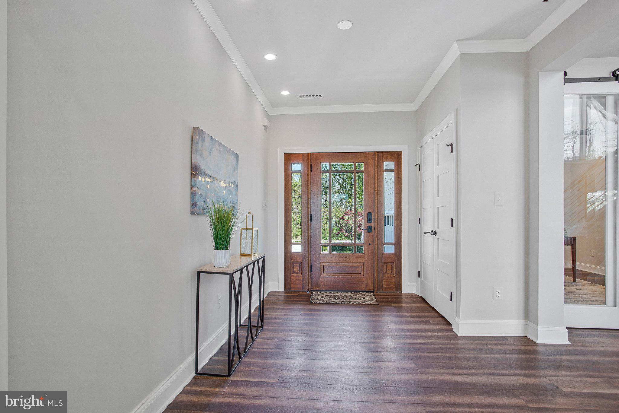 6146 Drum Point Road Deale, MD 20751 - Photo 5 of 75 a view of a hallway with wooden floor and windows