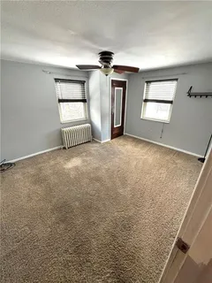 a room with wooden floor and white walls
