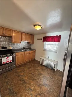 a kitchen with granite countertop a stove and a sink