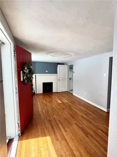 wooden floor in an empty room with a fireplace