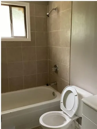 a bathroom with a toilet a sink and bathtub