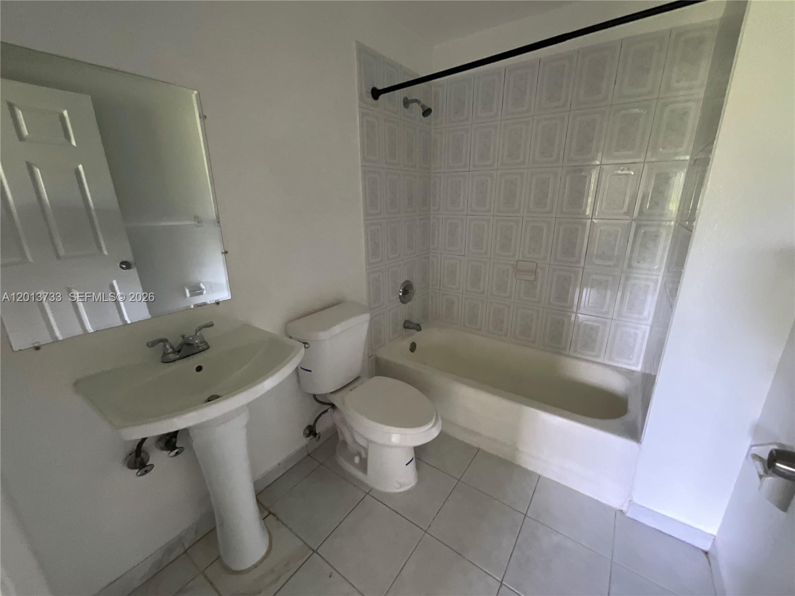 209 Northeast 141st Street, Unit 4 Miami, FL 33161 - Photo 12 of 13 a bathroom with a sink a toilet and shower