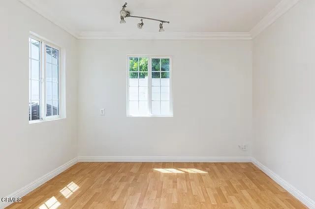 a view of a room with wooden floor and windows