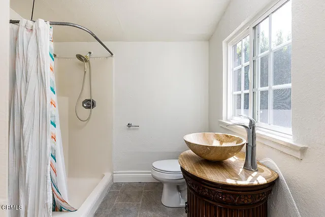 a bathroom with a toilet and a shower