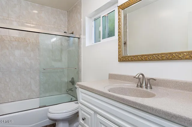 a bathroom with a sink a toilet and a shower