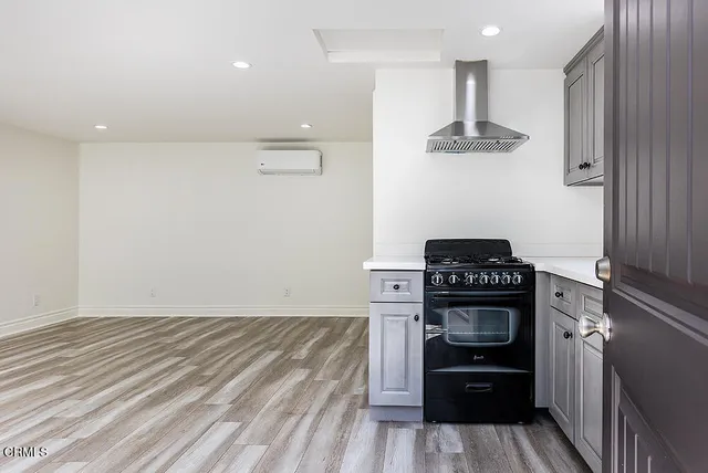 a kitchen with a stove and a refrigerator