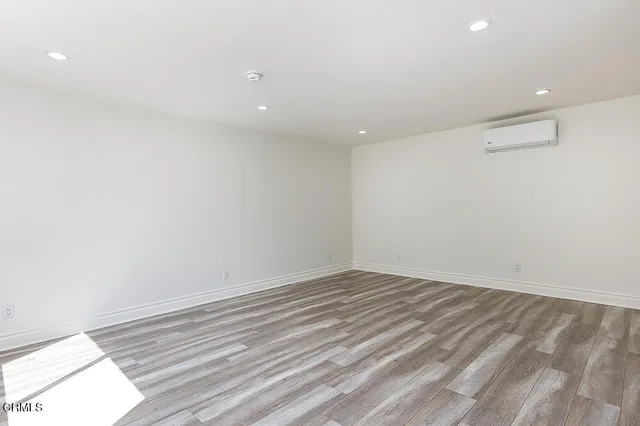 a view of room with wooden floor and fan
