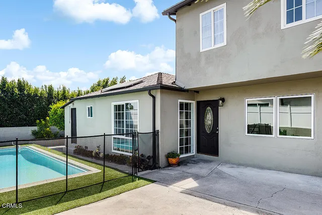 a view of a house with sitting area and backyard
