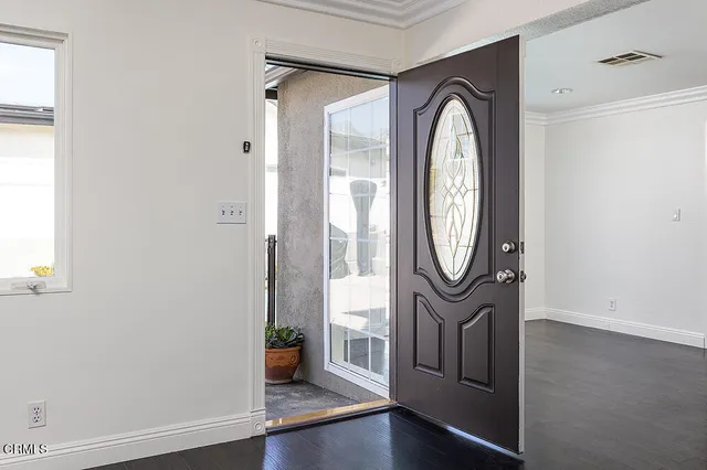 a view of a livingroom with wooden floor and a large window