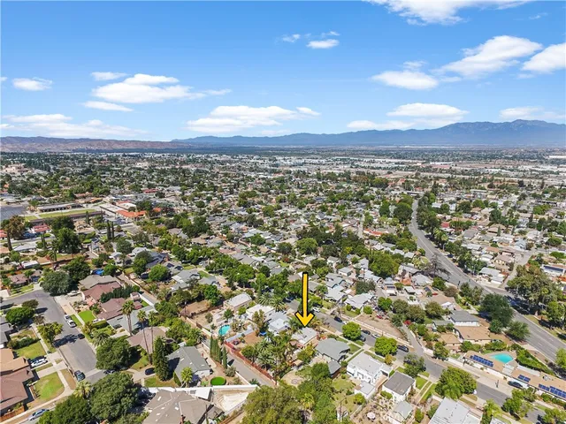 an aerial view of residential houses with city view