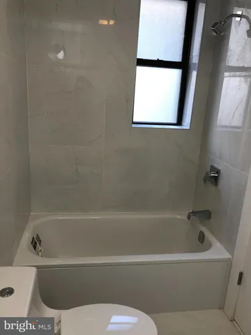 a bathroom with a bathtub and a window