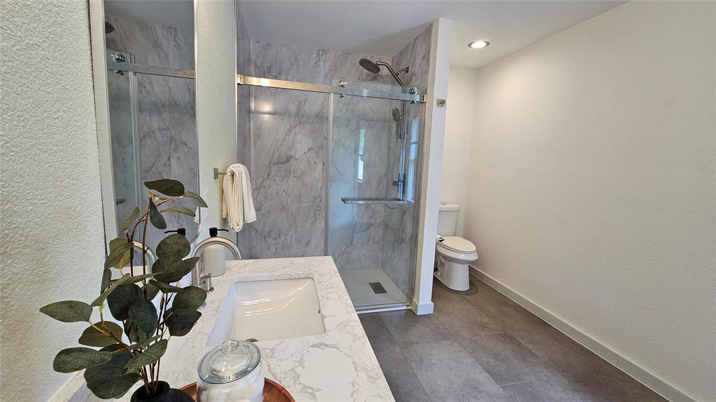 3437 Caprock Ranch Road Fort Worth, TX 76262 - Photo 24 of 27 a bathroom with a toilet and a shower