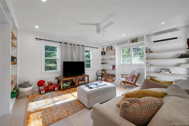 a living room with furniture a window and gym equipment