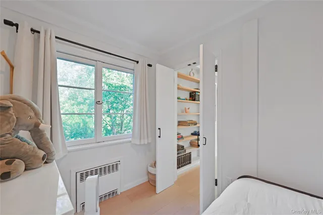 a bedroom with furniture and a window