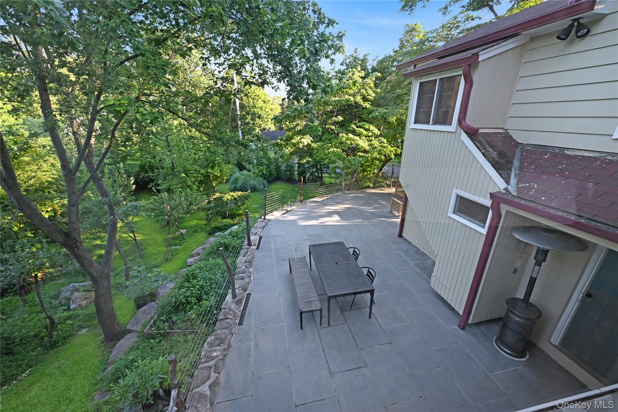 47 Mountainview Drive Tomkins Cove, NY 10986 - Photo 32 of 39 a backyard of a house with table and chairs with wooden fence