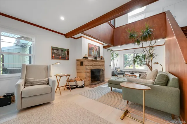 a living room with furniture a fireplace and a table