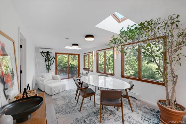 a living room with furniture flowerpot and window