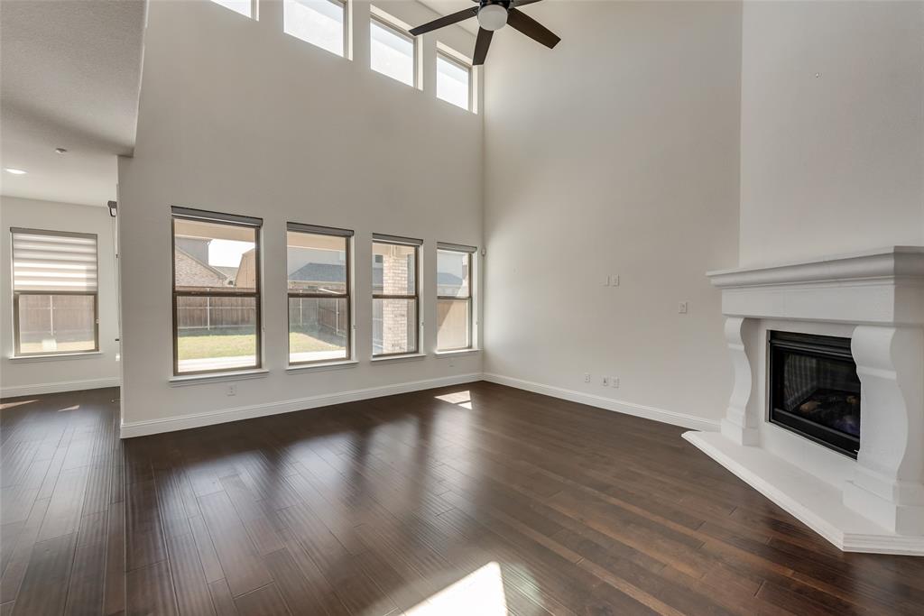 16476 Ryder Rock Road Frisco, TX 75033 - Photo 11 of 40 Stone fireplace and beautiful hard wood floors