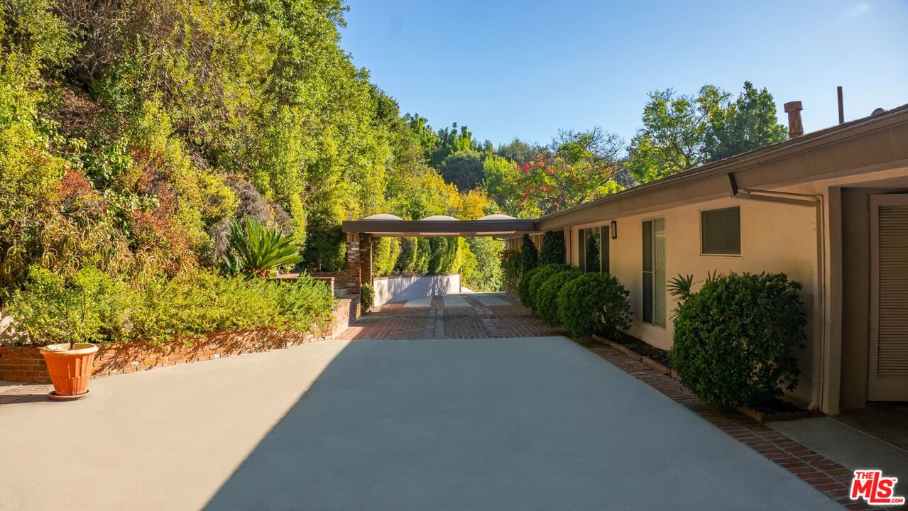 10895 Chalon Road Los Angeles, CA 90077 - Photo 18 of 19 a view of a house with a yard
