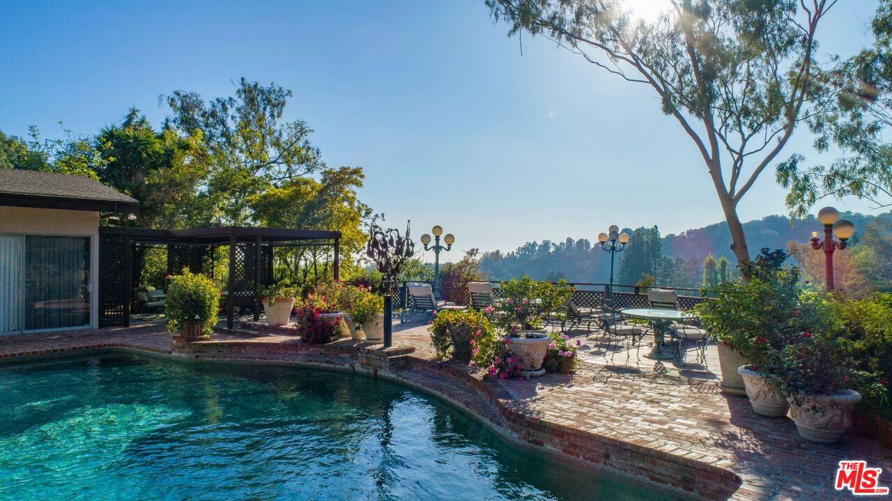 10895 Chalon Road Los Angeles, CA 90077 - Photo 8 of 19 a view of a backyard with plants and a patio