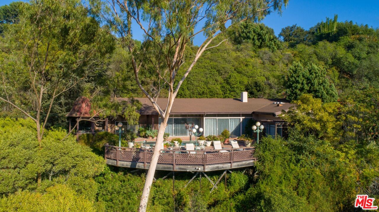 10895 Chalon Road Los Angeles, CA 90077 - Photo 10 of 19 a front view of house with yard and outdoor seating