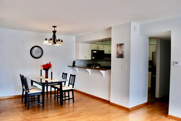 a view of a dining room with furniture and a chandelier