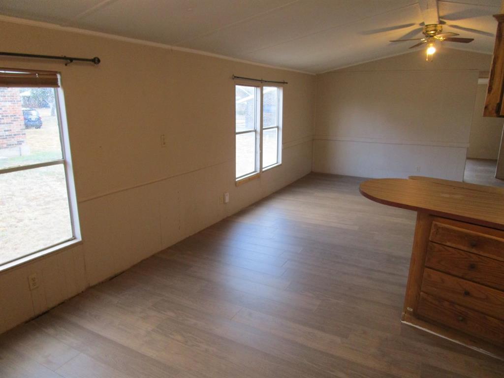800 Bluff Street Sweetwater, TX 79556 - Photo 15 of 19 a view of an empty room with wooden floor and a window