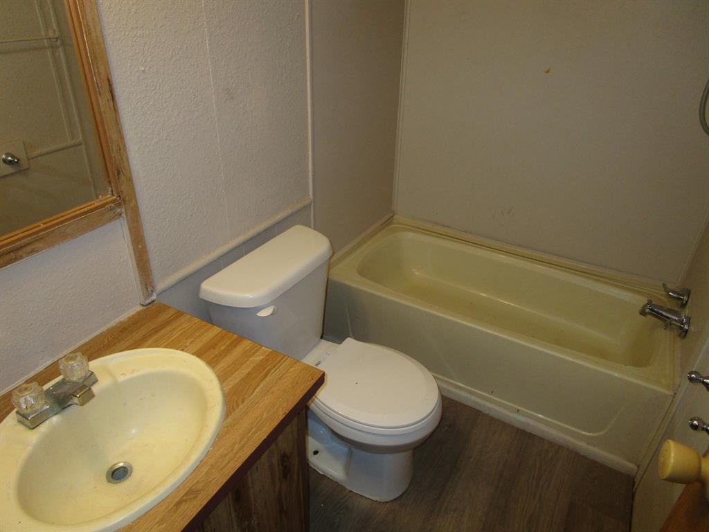 800 Bluff Street Sweetwater, TX 79556 - Photo 9 of 19 a bathroom with a sink and a mirror