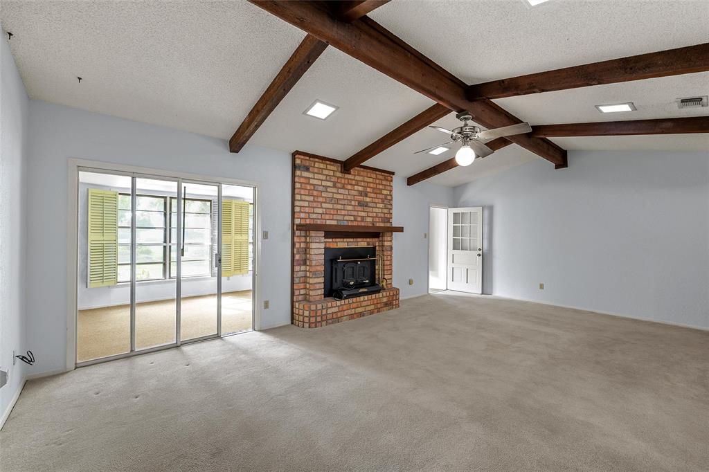 219 Opal Street Hewitt, TX 76643 - Photo 4 of 28 a view of an empty room with a fireplace and a large window