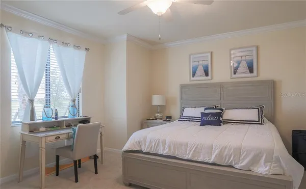 a bedroom with a bed and a chair