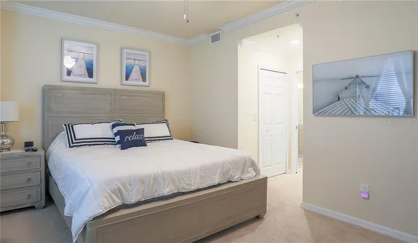 a bedroom with a bed and wall painting