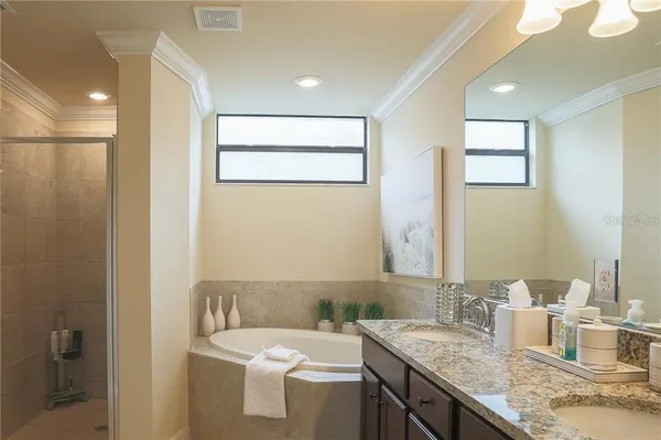 a bathroom with a granite countertop sink a toilet and a mirror
