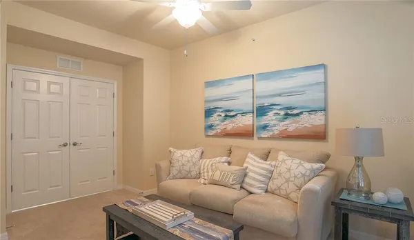 a living room with furniture and a lamp
