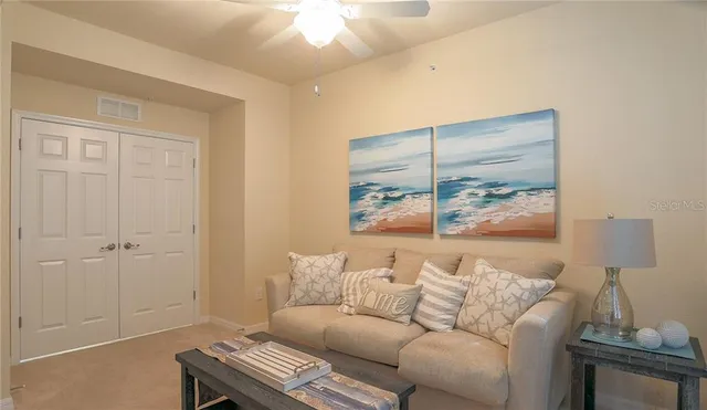 a living room with furniture and a lamp