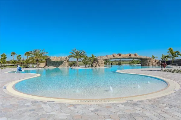 a view of a swimming pool with outdoor seating