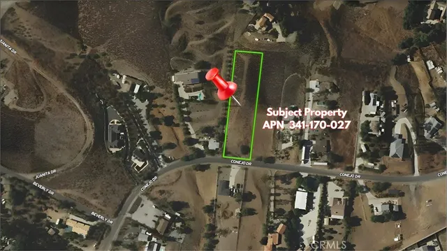 a green field with trees in the background