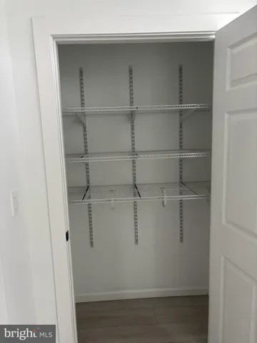 a bathroom with a granite countertop sink toilet a mirror and bathtub