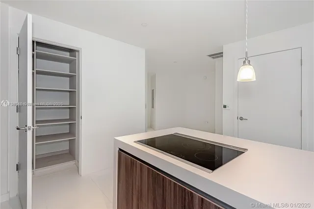 a view of a kitchen from a hallway
