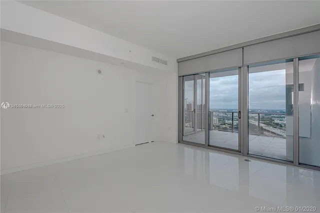 a view of an empty room with glass door