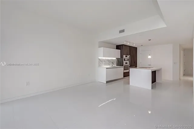 a view of kitchen with white cabinets