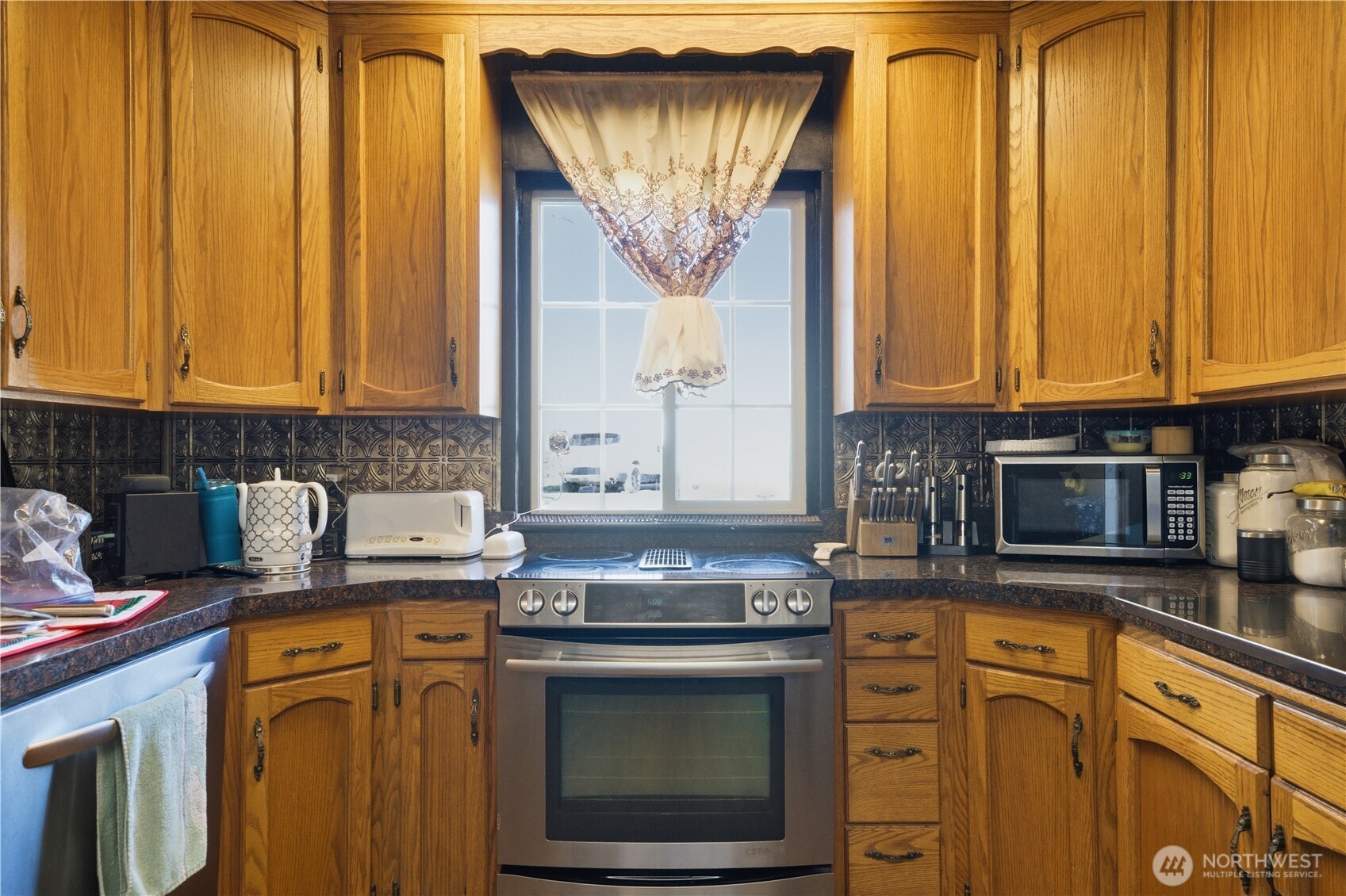 231 Main Street Waitsburg, WA 99361 - Photo 11 of 35 a kitchen with stainless steel appliances granite countertop a stove a sink and a microwave