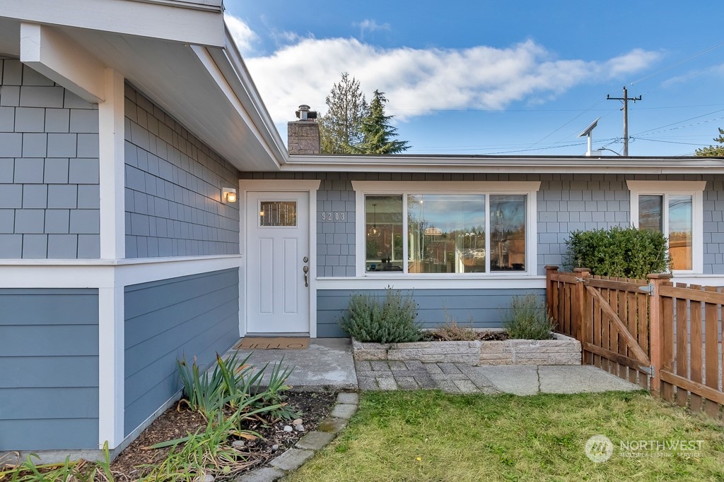 9203 29th Avenue Southwest Seattle, WA 98126 - Photo 1 of 25 a front view of a house with a yard
