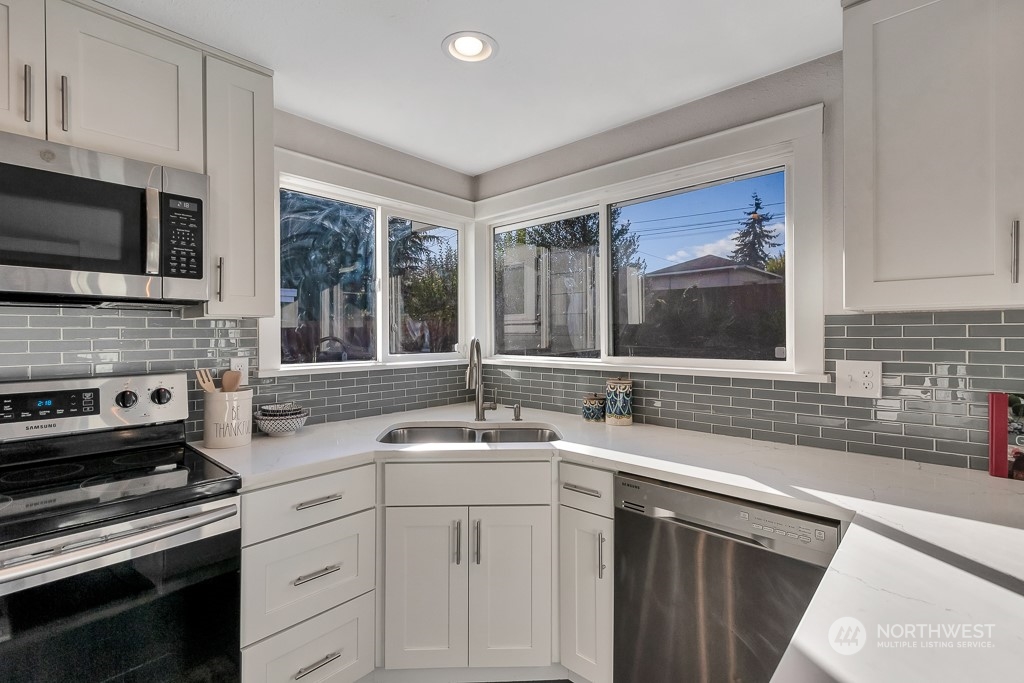 9203 29th Avenue Southwest Seattle, WA 98126 - Photo 16 of 25 a kitchen with a sink stove and microwave